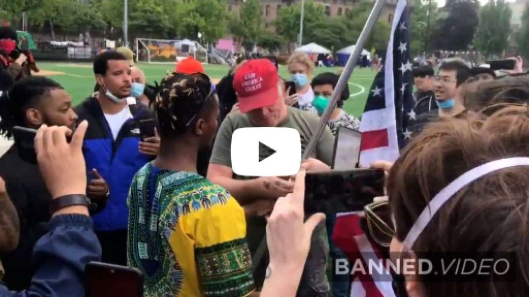 Man Wearing MAGA Hat Carries American Flag Through CHOP
